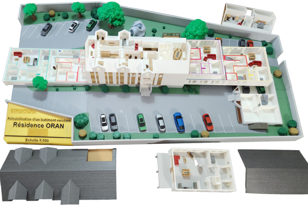 Maquette immobilière de résidence 1:100, tiroirs sortis montrant les logements différenciés par couleur
